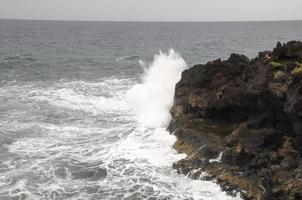 Waves hitting the rocks photo