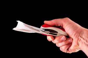 Hand stapling a paper photo