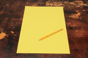 Yellow paper and pencil photo