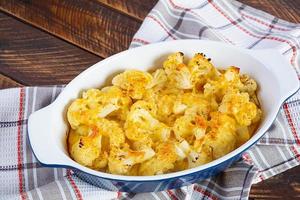 Diet food. Baked cauliflower with cheese, cream and eggs photo
