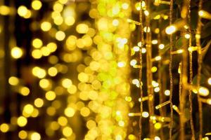 Blurred and bokeh of Christmas lights and refection lighting on black background. photo