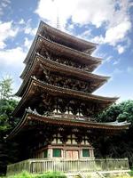Closeup wooden Five Storied Pagoda in Daigoji Temple on bright blue sky background, Kyoto, Japan photo
