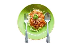 Top view of spaghetti tomato sauce and minced pork look tasty with spoon and fork on ceramic plate and isolate on white background. Make with paths photo