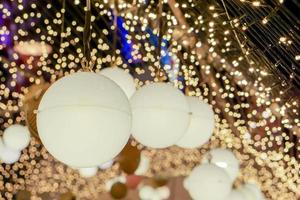 Decorate Christmas lamps hang interior    tunnel lights on blurred and bokeh of led reflection lightning in night time background. photo