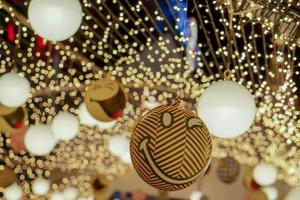 Decorate Christmas lamps and air balls hang interior tunnel lights on blurred and bokeh of led reflection lightning in night time background. photo