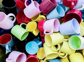 Top view and crop colorful heap of ceramic coffee cup fit on screen background and wallpaper.