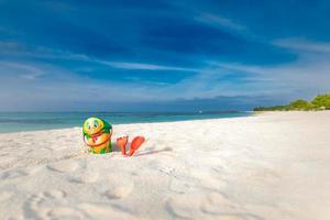 Children's beach toys - buckets, spade and shovel on sand on a sunny day. Topical island beach holiday, tourism background. Cute beach toys