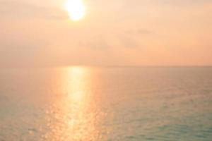 Aerial view of sea and beach with coconut palm tree on island at sunset time, blurred background, artistic sea sunset. photo