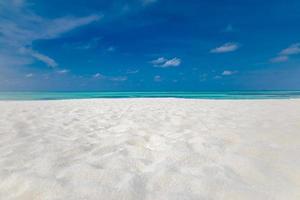 Idyllic perfect tropical white sandy beach and turquoise clear ocean water - summer vacation natural background with blue sunny sky photo