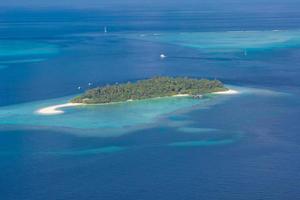 Maldives aerial panorama blue water reef, tropical nature view. Exotic travel destination photo