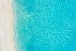 Sea aerial view, top view, amazing nature background. The color of the water and beautifully bright. Azure beach with white sand and clear water of ocean at sunny day. Flying drone, sea view photo