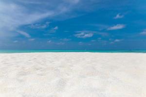 Idyllic tranquil tropical white sandy beach and turquoise clear ocean water - summer vacation natural background with blue sunny sky photo