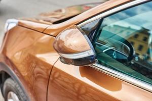 Parked car with automatic folding rear view mirror photo