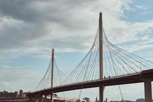 modern cable stayed bridge over the river against cloudy sky. photo