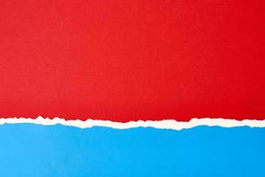Torn ripped paper edge with a copy space, red and blue color background photo