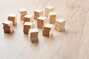 Stacked in the towers wood blocks on wooden table with copy space photo