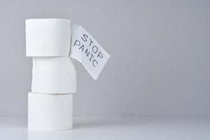 Toilet paper rolls with word stop panic photo