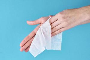 Woman wash hands using antibacterial napkin photo