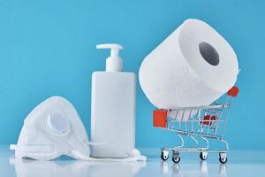 Toilet paper roll, sanitizer antiseptic gel and protective mask photo