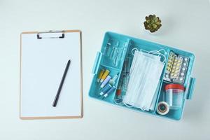 Top view of medical items and empty paper blank sheet on the white background photo