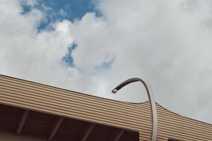 Part of modern bridge with street led lights against cloudy sky. photo