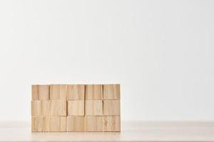 Wall made of wooden blocks on the white background. Finishing task concept photo