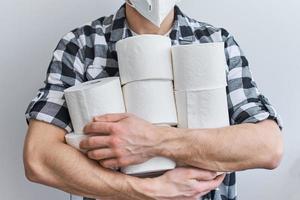 Man hold many rolls of toilet paper photo