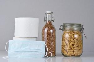 Toilet paper roll, pasta, buckwheat and protective medicine mask photo