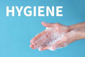 Woman wash hands using sanitizer or antiseptic gel photo