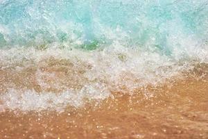 Sea wave on the sand beach, soft focus. Summer background photo