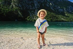 Baby girl against Lake Bohinj, the largest lake in Slovenia, part of Triglav National Park. photo