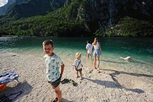 Kids and dog in Lake Bohinj, the largest lake in Slovenia, part of Triglav National Park. photo