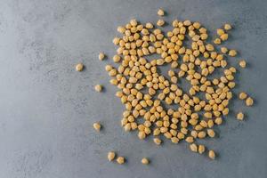 Top view of clean fresh garbanzo or chickpeas on grey background. Flat lay. Raw food for vegans. Close up. Ingredients full of protein photo