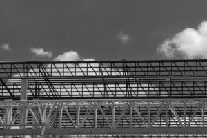 Heavy Steel Structural Gantry Crane for moving large slabs in a dangerous slab casting factory is being built strong and stable against a beautiful evening sky background. photo