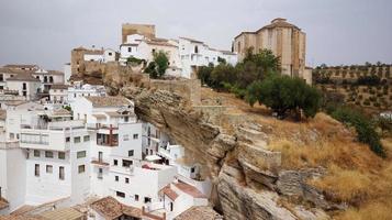 Aerial drone view of the village Setenil de las Bodegas, known for its whitewashed houses built into the surrounding cliffs. Touristic destination. Holidays and vacation. Travel the world. photo