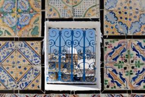 Closeup detailed shot of window with a view of the Old Medina of Tunis, Unesco. Around 700 monuments, including palaces, mosques and more testify to this remarkable historic city. photo