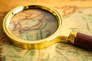 Bangkok, Thailand - May 01, 2022 Japan, Magnifying glass close up with colorful world map photo