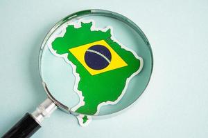 Brazil flag and magnifying glass with copy space. photo