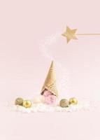 Magic wand casting a spell on an ice-cream lying upside down on a snow. Winter creative idea. photo