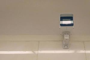 city video surveillance system - security camera under ceiling, front view photo