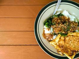 pecel rice with side dishes of tempeh and scrambled eggs photo