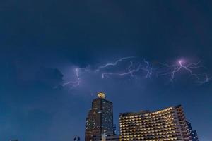 lightning strike over building area in Bangkok City at night, Thailand. photo