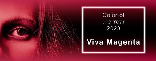 Viva Magenta - color of the year 2023. Trendy color sample. Toned picture with text. Beutiful banner with woman's eye. Fashion, style. photo
