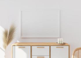 Empty picture frame on white wall in modern living room. Mock up interior in scandinavian, boho style. Close up view. Free space for your picture. Wooden console and pampas grass. 3D rendering. photo