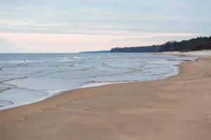 Baltic Sea Coast With Pebbles And Ice at Sunset photo