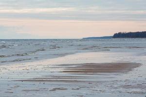 Baltic Sea Coast With Pebbles And Ice at Sunset photo