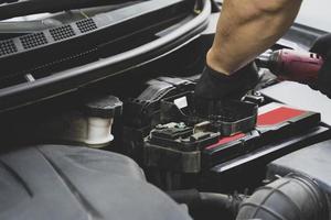 Picture of car parts and bumper repairman in front of car photo