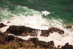 Waves crashing on coastal rock formations photo