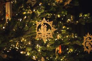 Wooden Christmas decoration on tree photo
