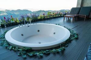 bath tub on balcony with mountain hill background photo